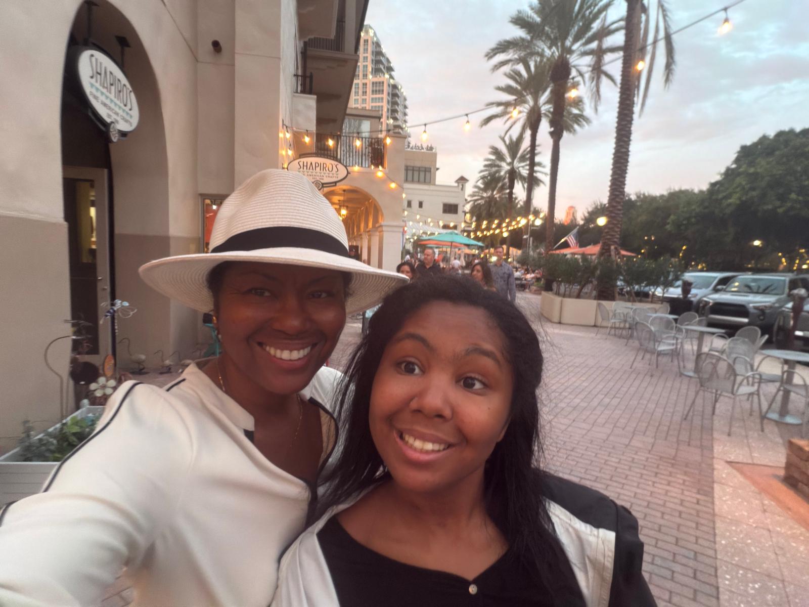 Kimberly and her daughter smiling outside Shapiro's on an evening out